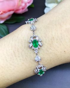 A DREAM COMES TRUE! Gorgeous masterpiece! ONE OF A KIND Bracelet! Featuring 6 pieces of extra fine GLOWING BRIGHT GREEN Zambian Emerald weighting a total of 4.05 carats... and OVER 138 pieces of SPARKLING, top-grade, F/VS Diamonds (2.28 carat in total). SET IN ONE-OF-A-KIND 18K Solid White Gold, meticulously designed and handcrafted BRACELET! A true heirloom piece that can transcend beyond times and eras.... EMERALDS: Weight: 6 pieces 4.05 carats (about 0.7 carat each) Shape: OVAL CUT Dimensions Emerald Tennis Bracelet With 17 Jewels For Wedding, Emerald Diamond Bracelet For Wedding, Elegant Emerald Diamond Bracelet For Wedding, Wedding Emerald Diamond Bracelet, Fine Jewelry Emerald Diamond Bracelet For Wedding, Elegant Emerald Tennis Bracelet For Wedding, Formal Silver Diamond Bracelet With Emeralds, Exquisite Hand Set Oval Bracelets, Exquisite Oval Wedding Bracelets