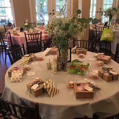 a table set up with boxes and flowers