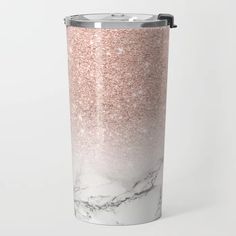 a pink and white marble tumbler with glitter on it