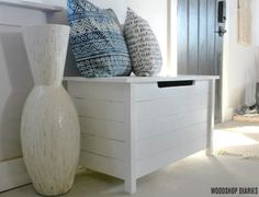 three blue and white vases sitting on top of a wooden crate next to a fireplace