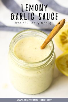 lemony garlic sauce in a glass jar with a wooden spoon