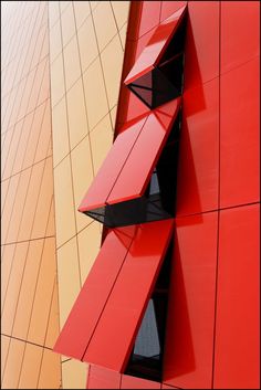 the side of a building with red and yellow panels