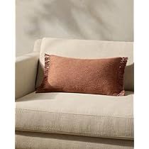 a white couch with a pink pillow on it