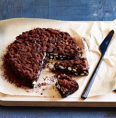 a piece of cake on a cutting board next to a knife