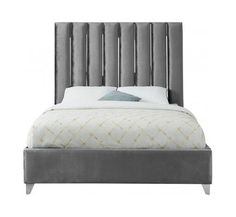 an upholstered bed with grey velvet headboard and foot board, on a white background