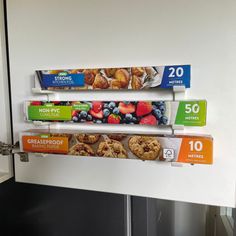 three boxes of cereal are hanging on the wall