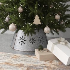 a christmas tree in a bucket with presents under it