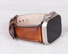 Our handcrafted burnished tan classic leather strap will add a timeless elegance to your Apple Watch. This band is made from high-quality full-grain leather and crafted to match your Apple Watch while offering remarkable comfort & style. Completely Handmade Genuine Full-Grain Leather Durable, Stylish & Timeless Design Stainless-Steel Buckles - Secure & Strong Compatible with all Apple Watch Series (including Apple Watch 10 & Ultra 1-2). New Apple Watch, Brown Leather Strap, Leather Watch Bands, Silicon Bands, Beautiful Watches, Nice Leather, Black Hardware, Apple Watch Band, Leather Care