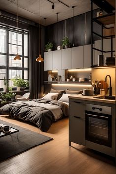 a bed sitting in a bedroom next to a kitchen and living room filled with furniture