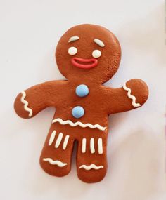 a cookie shaped like a ginger with white and blue icing on it's face