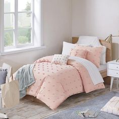 a bed room with a neatly made bed next to a dresser and window in it