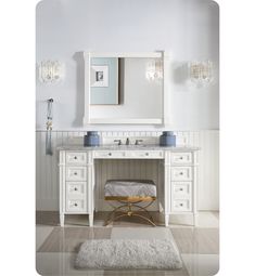 a white bathroom vanity with two sinks and a mirror