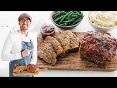 a man standing in front of a cutting board with meat and vegetables on it next to mashed potatoes