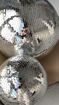 two shiny disco balls sitting next to each other