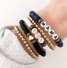 "Brand new to the Louis and Finn, our heishi beads have quickly become an arm party must have! So cute! So fun! Personalize with your wording and pick your favorite color from the drop down menu. Pick from our beautiful navy blue, white or black discs and pair them with one of our 5 mm gold metal beaded bracelets! We have now added the option to shop this EXACT look! If you select \"set of 5 bracelets\" from the dropdown menus, the bracelets will come as displayed (2 gold beaded solids, white wi Trendy Heishi Beaded Bracelets As Gift, Trendy Heishi Beads Bracelet As Gift, Trendy Heishi Beads Bracelet For Gift, Handmade Heishi Beads Name Bracelet For Everyday, Stackable Heishi Beads Friendship Bracelets, Casual Heishi Beads Bracelets As Gift, Black Heishi Beads Jewelry For Friendship, Everyday Heishi Beads Bracelet, Adjustable Heishi Beads Bracelet For Birthday