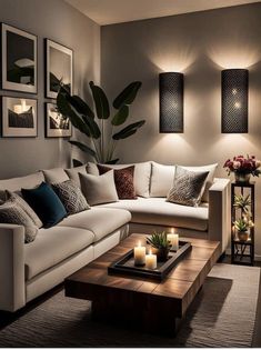 a living room filled with lots of furniture and candles on the coffee table in front of it