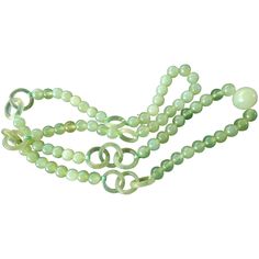 On offer is this beautiful vintage Chinese carved Translucent Pale Green Jade Necklace. It features 8mm large jade beads and a large 15mm Opaque pale green central bead joined together with exquisitely hand carved open work interlocking rings known as Devil's Work. In The Collectors Book of Jade (1978), the Chu's say "this elaborate open work...was commonly referred to as devil's work because it was hardly possible for human hands". They estimate it would take almost a week to carve and polish a Elegant Round Jade Beaded Necklaces, Elegant Jade Jewelry With Large Beads, Elegant Jade Beaded Necklace With 8mm Beads, Vintage Jade Jewelry Hand-strung, Vintage Hand-strung Jade Jewelry, Vintage Jade Jewelry With Round Beads, Elegant Jade Gemstone Beads, Elegant Round Jade Beads, Vintage Single Strand Jade Jewelry