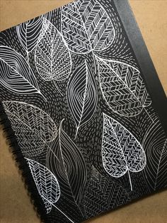 a notebook with black and white designs on it