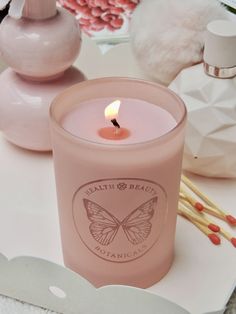 a pink candle sitting on top of a table