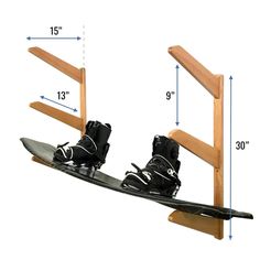 a pair of skis and snowboard are on a wooden stand with measurements for each one