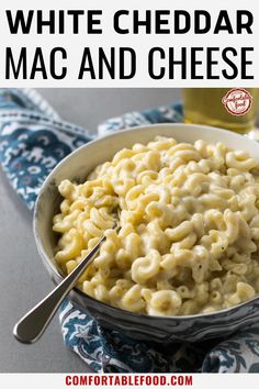 white cheddar mac and cheese in a bowl with a spoon next to it