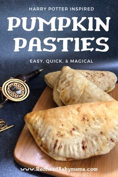 two pumpkin pasties on a wooden cutting board