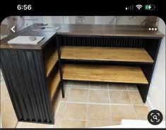 an image of a kitchen counter top made out of metal and wood with shelves on each side