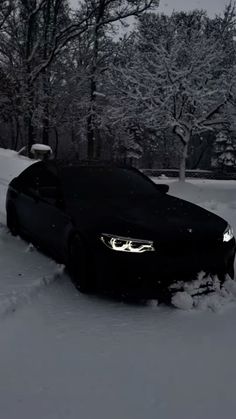 a black car is parked in the snow