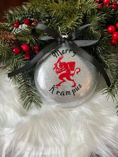 a silver ornament with a lion on it and merryramplus lettering