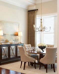 a dining room table with chairs and a chandelier