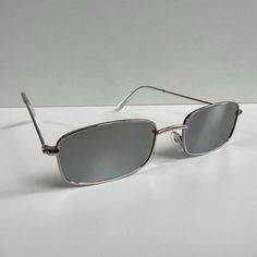 Vintage Y2k 90s 2000s Unique Slim Style Silver Trim Mirror Lens Sunglasses Silver Trim With A Mirror Lens These Sunnies Are Unisex! Uva And Uvb Protection Brand New #Sunglasses #Shades #Sunnies #Fashion Silver Sunglasses For Summer Streetwear, Trendy Silver Rectangular Sunglasses, Silver Rectangular Sunglasses With Mirrored Lenses, 2000s Glasses, Vuarnet Sunglasses, 2000s Men, Alexander Mcqueen Sunglasses, Sunglasses Men Vintage, Oliver Peoples Sunglasses