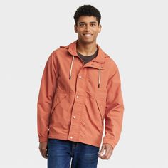 Refresh your wet-weather staples with this Elevated Rain Jacket from Goodfellow & Co™. This stylish elevated jacket in a solid orange color makes a versatile pick for rainy days. Made from water- and wind-resistant material, this hooded jacket features a lightweight construction to keep you dry, warm and comfortable at all times. The full-length zipper and snap closures allow for easy layering, while the elastic cuffs provide a snug fit. Plus, the front pockets allows you to carry small essentia