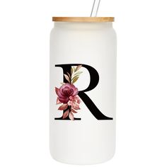 the letter r is painted on a white mason jar with a wooden lid and a floral monogrammed design