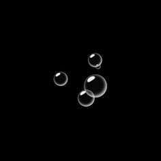 three bubbles floating in the air on a black background