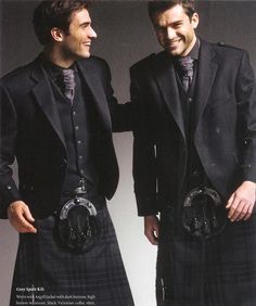 two men in kilts standing next to each other