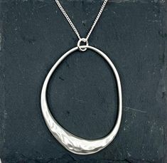 Simple oval shape pendant necklace. A safe choice for any occasion. Look beautiful on the skin or with a sweater. Statement necklace ideal for a gift. Chain length: 77cm + 8cm approx Pendant: 6.6*4.7cm approx  Not water resistant Avoid contact with perfume, heat, soaps Free delivery to UK customers Silver Necklace With Oval Pendant, Silver Oval Pendant Necklace For Everyday, Silver Hammered Oval Pendant Necklace, Minimalist Silver Oval Necklace, Modern Silver Necklace With Oval Pendant, Silver Oval Necklace For Everyday, Everyday Silver Oval Necklace, Oval Hammered Necklace As Gift, Oval Hammered Necklace For Gift