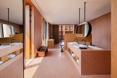 a bathroom with two sinks and mirrors on the wall next to each other in front of large windows