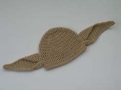 a crocheted hat is laying on a white surface, with the top part of it's brimmed