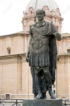 a statue in front of a building with a dome