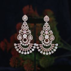 Rose gold American diamond Chandbali earrings studded with CZ color stones available in Pink, Mint green, white and Baby Pink colors . The traditional, ethnic design is crafted with high-quality materials for long-lasting shine. Perfect for adding a touch of elegance to any ensemble. Elegant Pink Earrings For Reception, Rose Gold Drop Earrings For Festive Occasions, Fusion Style Party Chandbalis With Hand Set, Diwali Party Hand Set Chandelier Earrings, Pink Hand Set Earrings For Celebration, Festive Cubic Zirconia Earrings For Celebration, Festive Rose Gold Earrings For Gift, Party Chandbali Earrings With American Diamonds, Elegant Pink Chandbali Chandelier Earrings