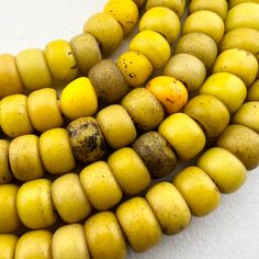 Old yellow Padre Beads - rare color - from Ethiopia. Made in Bohemia in the late 1800's or early 1900's and traded to Africa.  95 beads 24" of beads 61cm 26"  with raffia 8 to 9mm by 6 to 7mm 2 to 2.5mm hole African Trade Beads, African Beads, Trade Beads, Ethiopia, Seattle, Beads, Yellow, Color