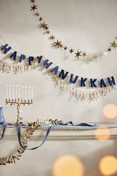 a hanukkah banner hanging on the wall next to a menorah