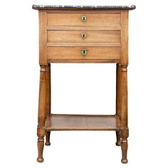 an old wooden nightstand with marble top