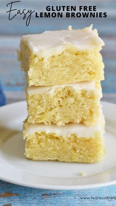 three pieces of cake sitting on top of a white plate next to a blue napkin