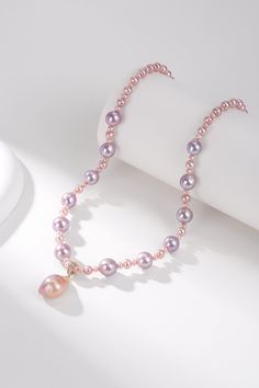 Pink Purple Baroque Freshwater Pearl Necklace with Detachable Pendant Adorn yourself with our Pink Purple Baroque Freshwater Pearl Necklace, featuring a detachable large pendant. This exquisite piece is crafted from varied sizes of Baroque pearls, linked together to form a 43-45cm necklace. At the centerpiece is a stunning 11-13mm Baroque pendant in a vibrant pink-purple hue, which can be removed for versatile styling. The unique shape and dazzling color of the pearls enhance its luxurious appea Pink Pearl Necklace With Pearl Pendant, Pink Pearl Necklace With Round Beads And Pendant, Elegant Pink Pearl Necklace With Pendant, Pink Pearl Drop Pendant Necklace, Elegant Pink Pearl Pendant Necklace, Elegant Pink Pendant Pearl Necklace, Elegant Pink Pendant Beaded Necklace, Pink Baroque Pearl Necklace With Pendant, Elegant Pink Baroque Pearl Necklace