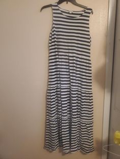 This J.Crew sleeveless midi dress is perfect for any casual or travel occasion. The black and white striped pattern adds a touch of sophistication, while the round neckline and cap sleeves keep it practical for warmer seasons. The dress is made of 100% cotton knit fabric, making it comfortable and machine washable for easy care. The zip closure and accents such as the zipper add a unique touch to the dress. This dress is a size L and is suitable for regular size types. It is a great addition to Strip Dress, Stripped Dress, Sleeveless Midi Dress, Fabric Making, Midi Dress Sleeveless, Cotton Knit, Dress Clothes For Women, Round Neckline, Cap Sleeves