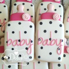 baby shower cookies decorated with pink and black polka dots