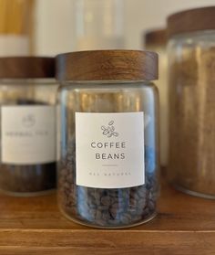 coffee beans in glass jars with labels on them