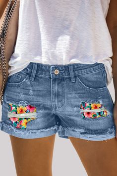 Sky Blue Distressed Flower Patch Rolled Hem Denim Shorts Spring Vacation Denim Jeans, Mid-rise Jeans For Spring Vacation, Mid-rise Jeans For Vacation In Spring, Spring Vacation Mid-rise Jeans, Spring Beach Denim Jean Shorts, Spring Beach Cutoff Jeans, Casual Medium Wash Floral Print Bottoms, Medium Wash Jean Shorts For Beach In Spring, Mid-rise Jean Shorts For Spring Vacation