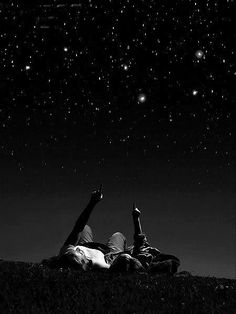 two people laying down under the stars in the night sky with an inspirational quote above them